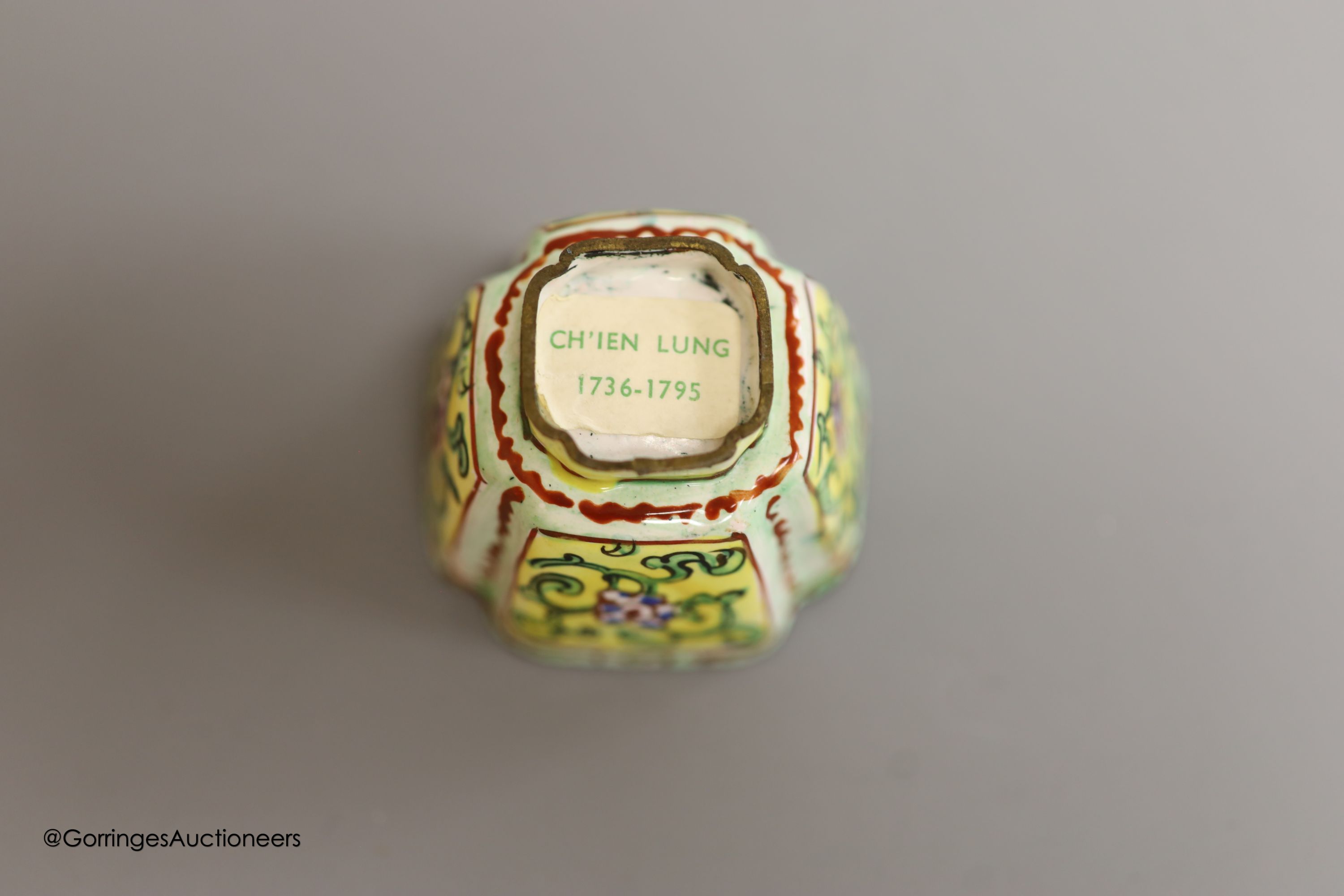 Two Chinese white metal salt and pepper shakers, 9cm and a Canton enamel cup.